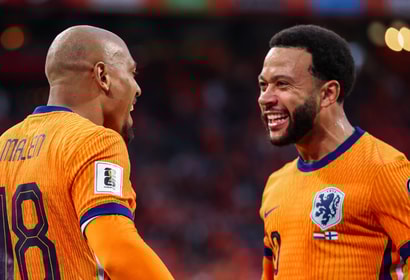 Donyell Malen viert een doelpunt met Memphis Depay