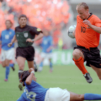 Dennis Bergkamp ontwijkt een sliding